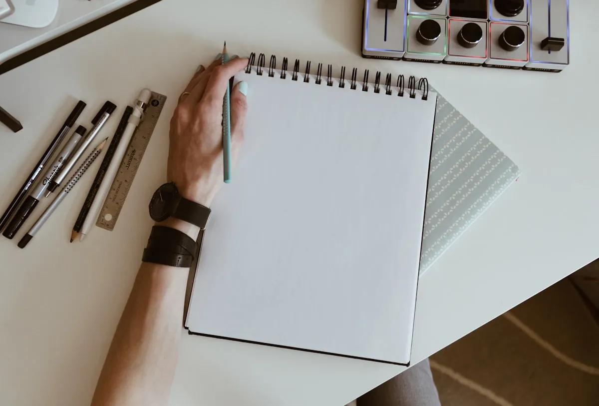 An open notebook and pens on a desk