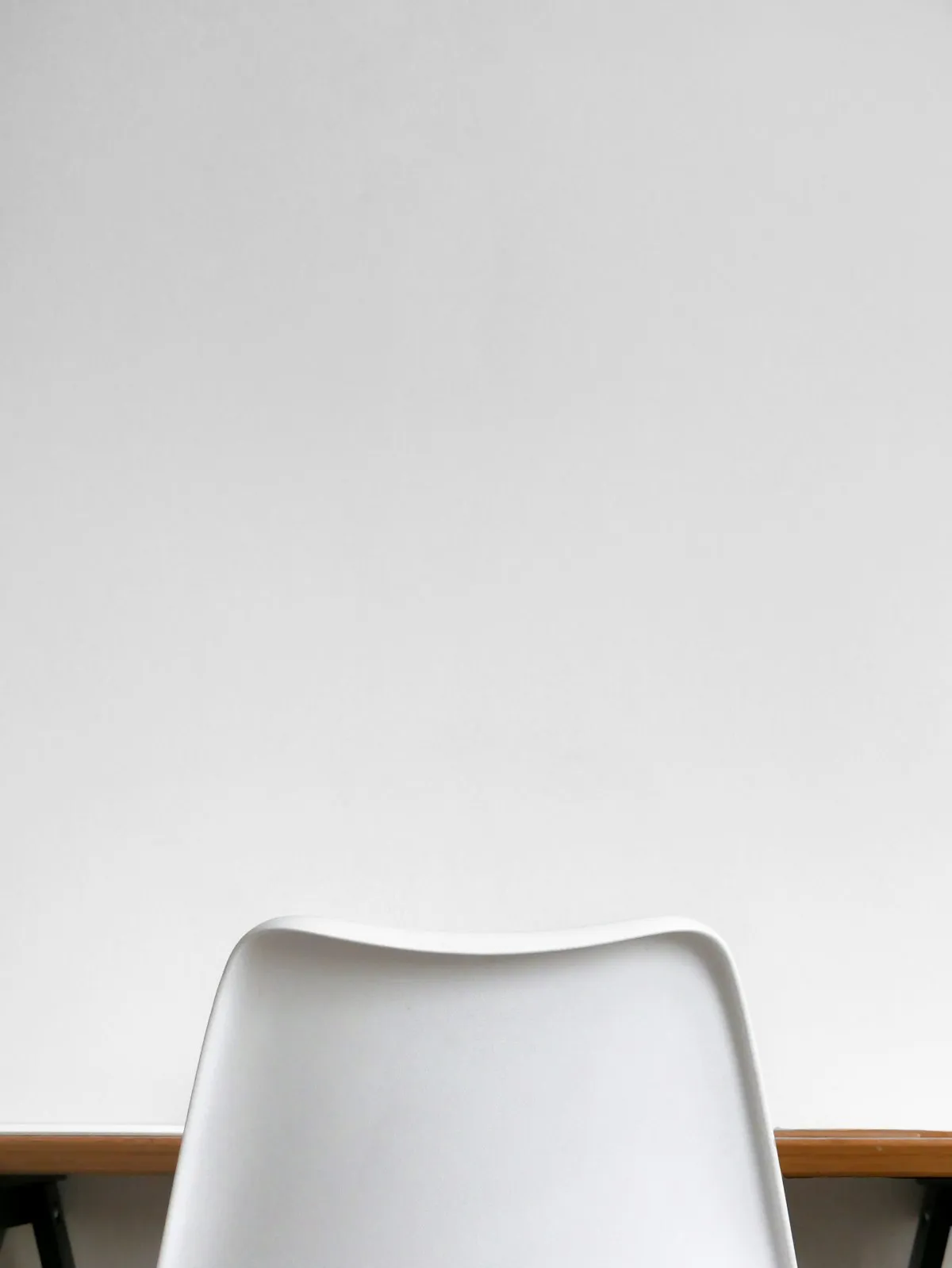 A calm room with a chair and table beside a window